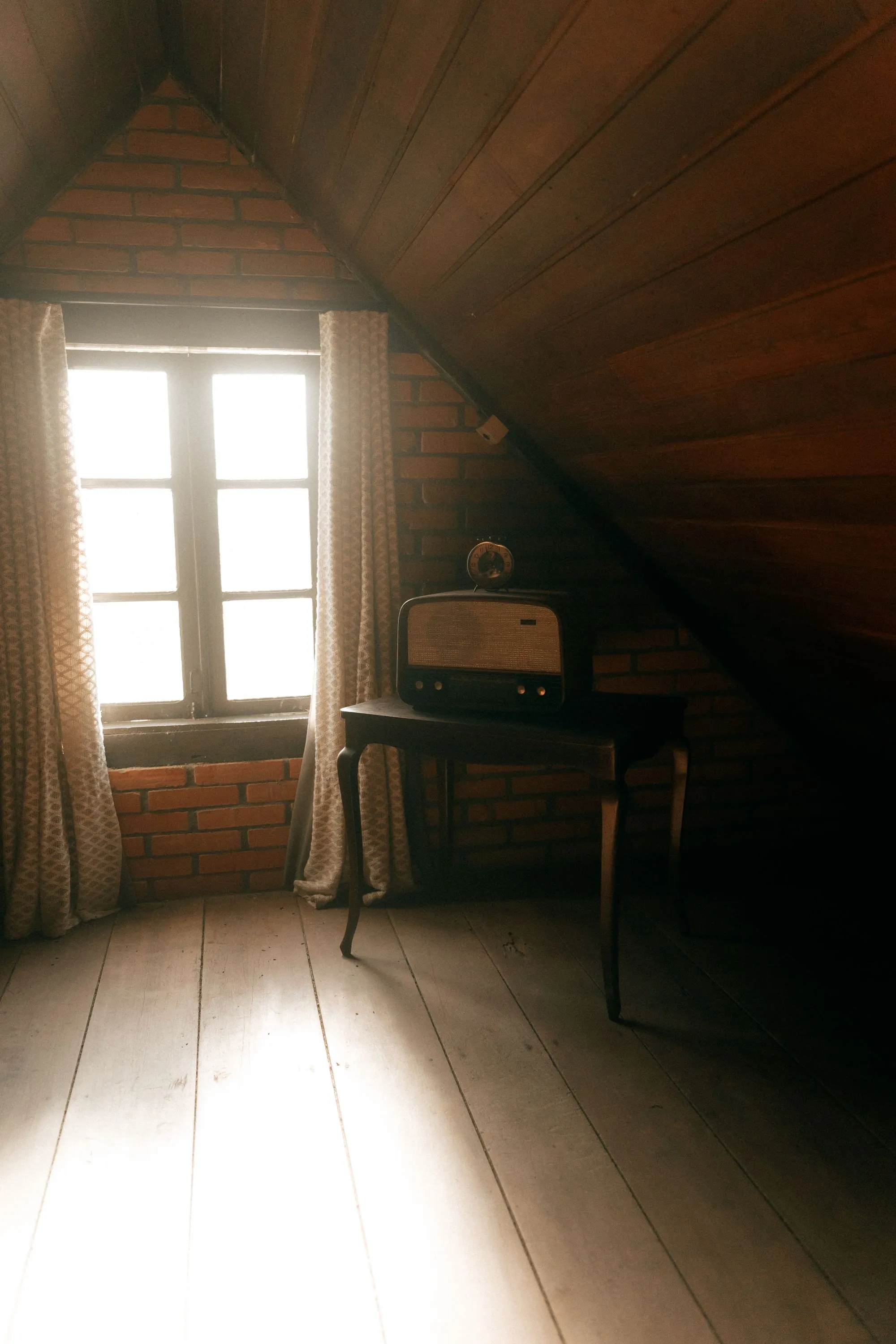 A loft interior lit through a small window