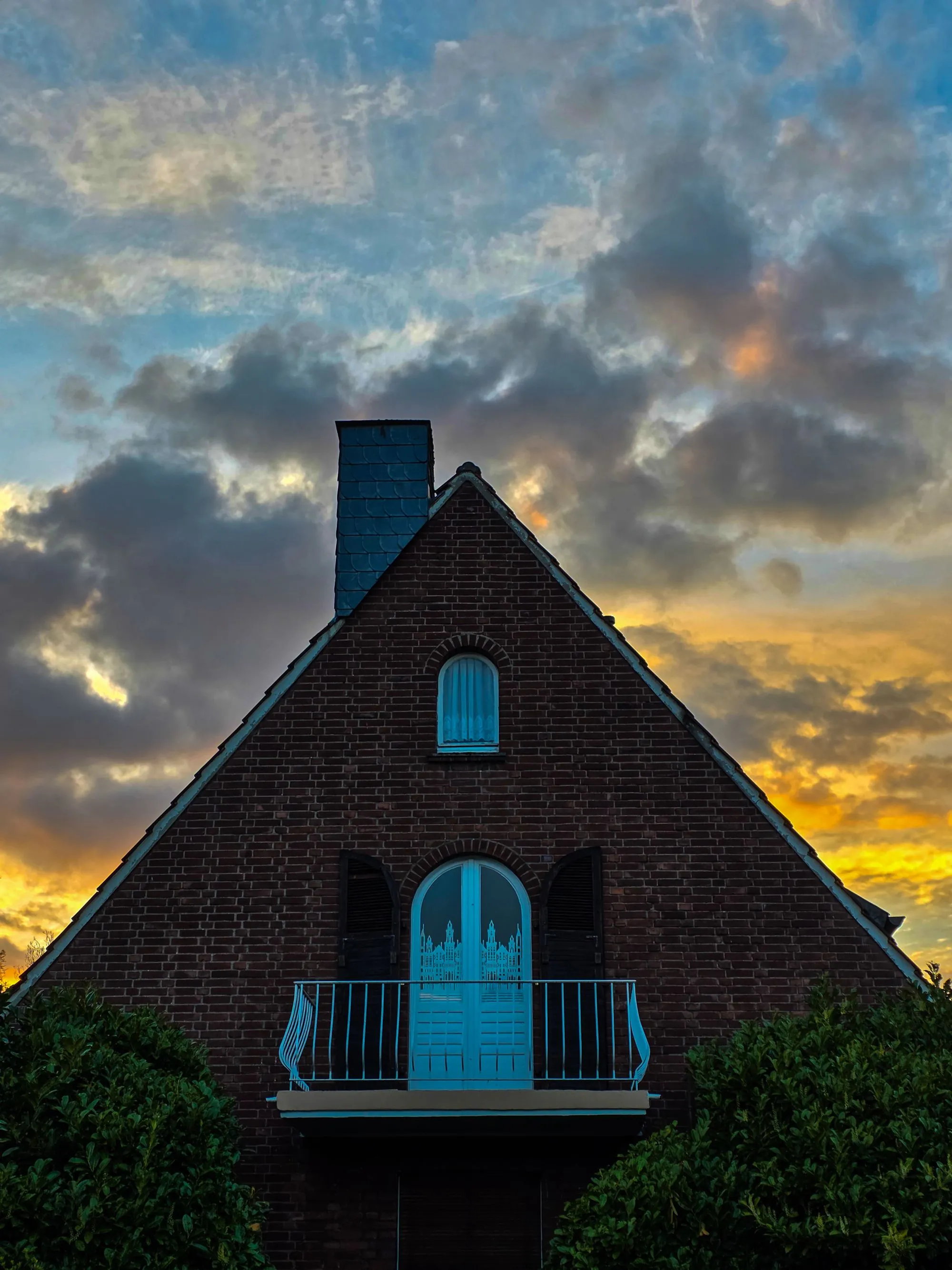 A house gable against a dramatic evening sky