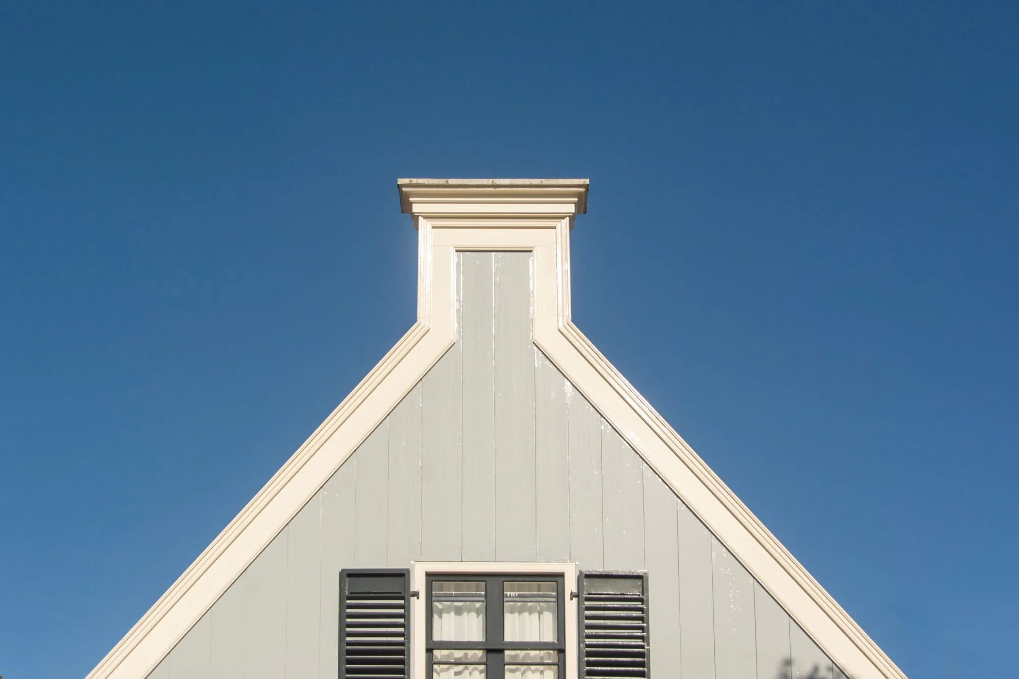 A white gable and roofline seen from below