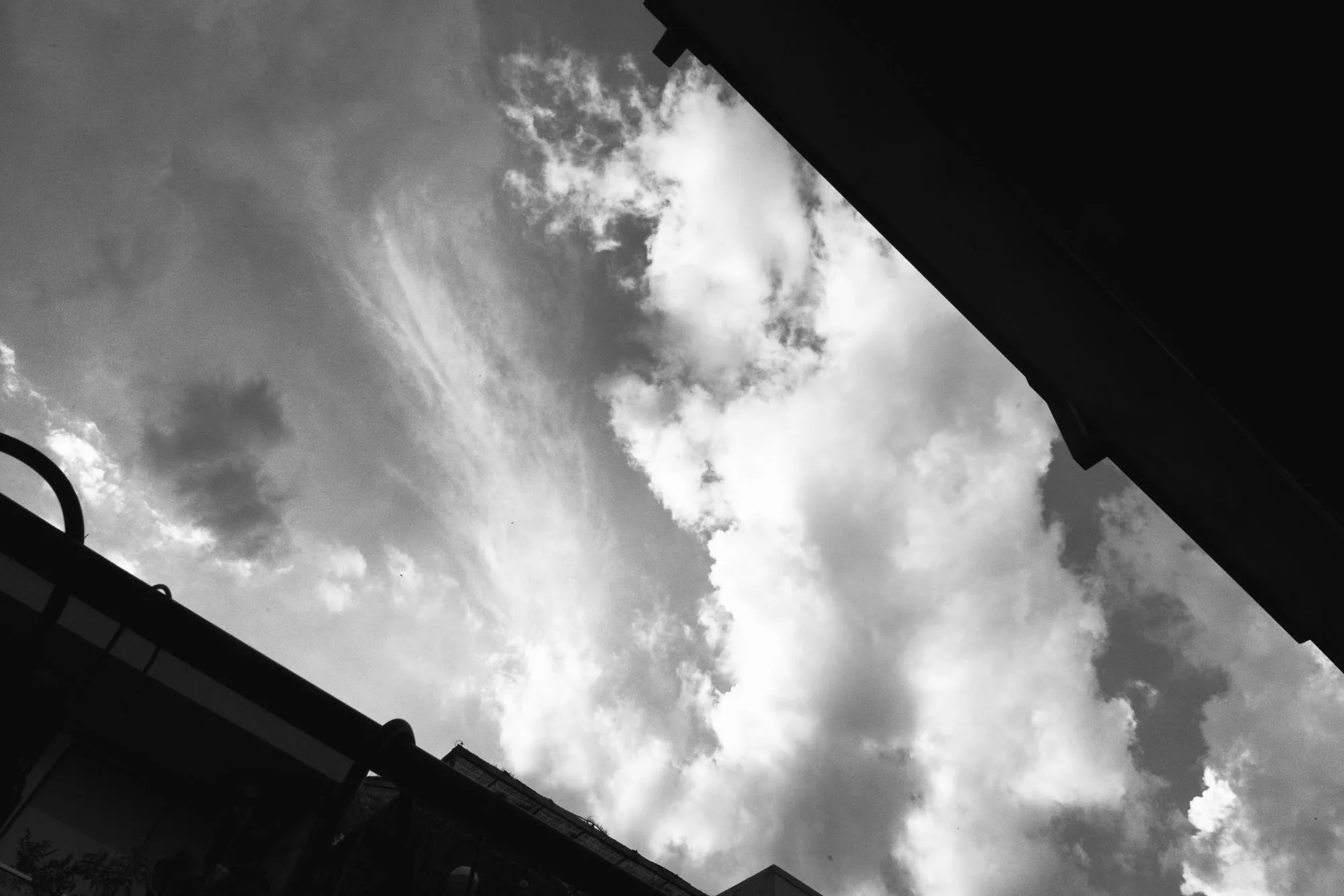 Storm clouds building above a rooftop